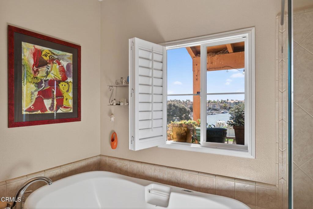 4337 Admiral Way Oxnard, CA 93035 - Photo 37 of 67 a bathroom with a tub and a window