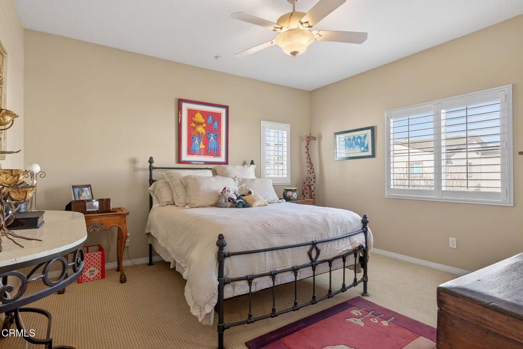 4337 Admiral Way Oxnard, CA 93035 - Photo 41 of 67 a bedroom with a bed a chandelier and a dresser