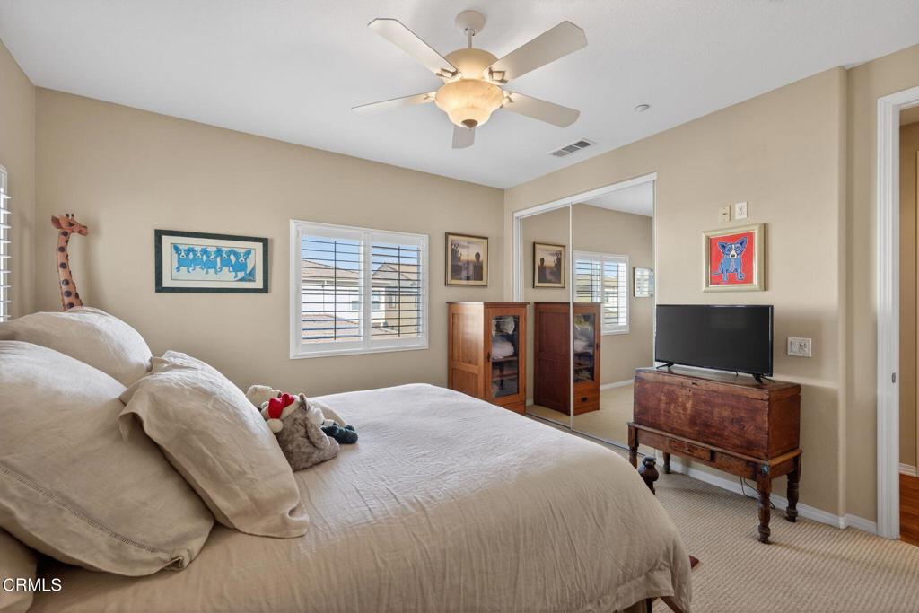 4337 Admiral Way Oxnard, CA 93035 - Photo 42 of 67 a bedroom with a bed and a chandelier