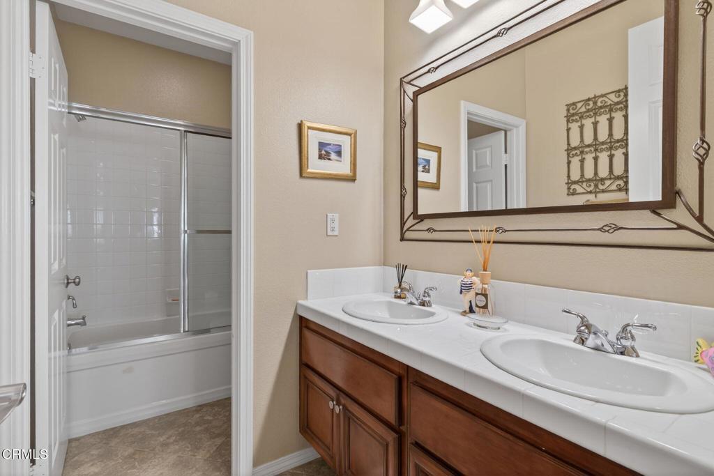 4337 Admiral Way Oxnard, CA 93035 - Photo 43 of 67 a bathroom with a bathtub shower sink and mirror