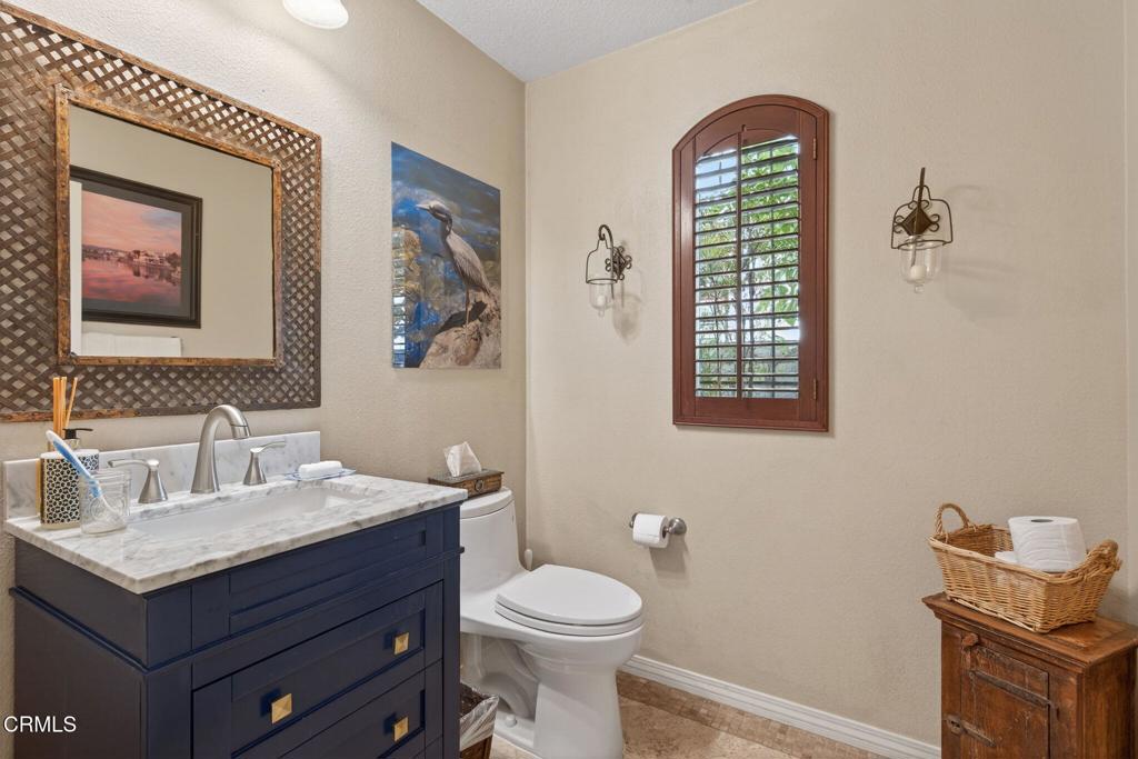 4337 Admiral Way Oxnard, CA 93035 - Photo 46 of 67 a bathroom with a toilet sink and mirror