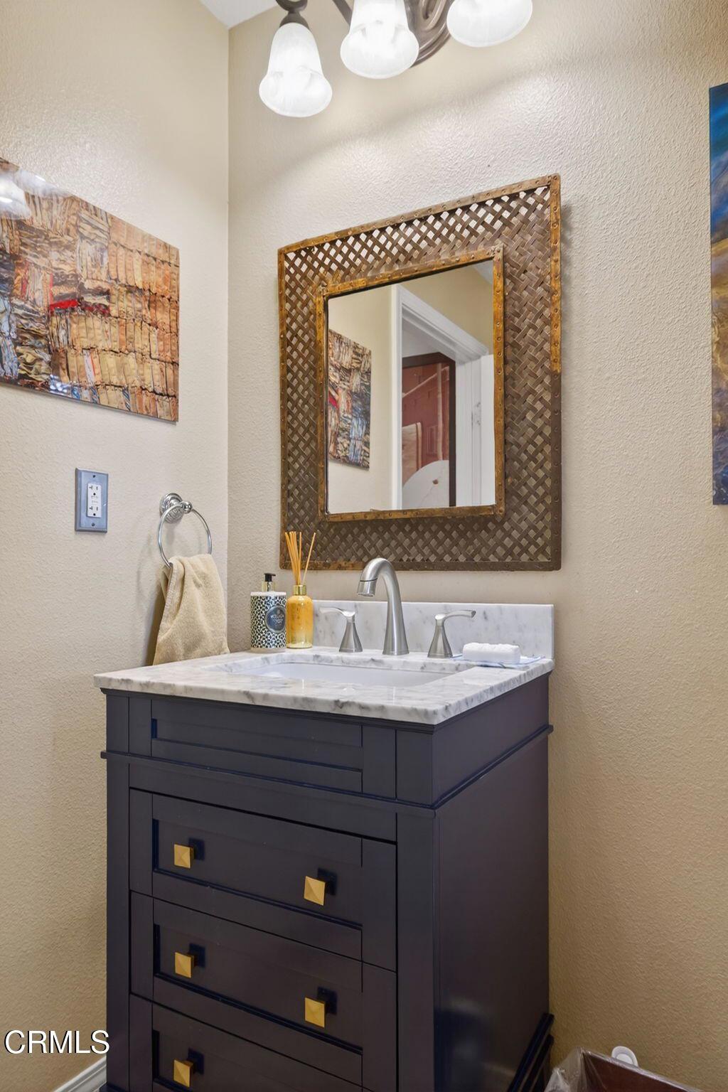 4337 Admiral Way Oxnard, CA 93035 - Photo 47 of 67 a bathroom with a sink and a mirror