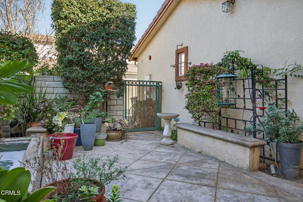 4337 Admiral Way Oxnard, CA 93035 - Photo 49 of 67 a view of a patio with table and chairs potted plants and large tree