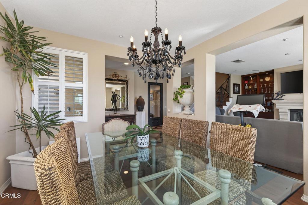 4337 Admiral Way Oxnard, CA 93035 - Photo 9 of 67 a living room with furniture a chandelier and a dining room