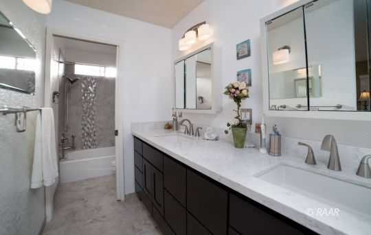 4617 West Ridgecrest Boulevard Ridgecrest, CA 93555 - Photo 4 of 33 a bathroom with a double vanity sink a mirror a shower and a bathtub