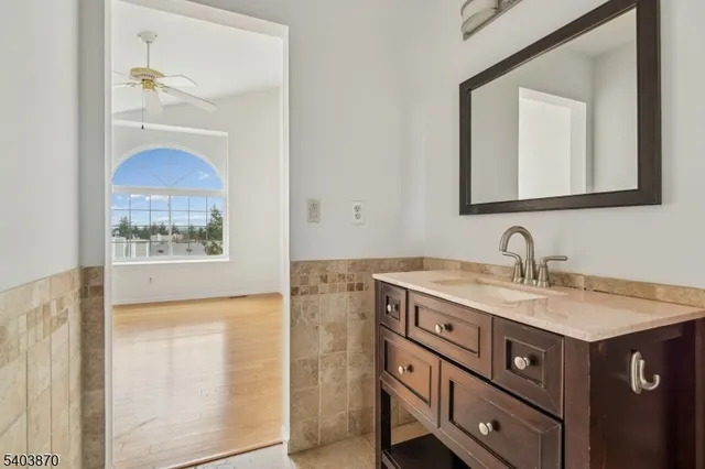 a bathroom with a sink vanity and a mirror