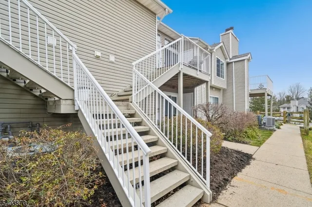 a view of a house with wooden deck