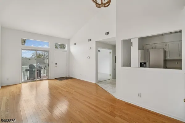 a view of empty room with wooden floor