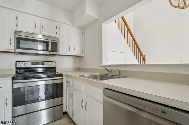 a kitchen with stainless steel appliances granite countertop a sink and a microwave