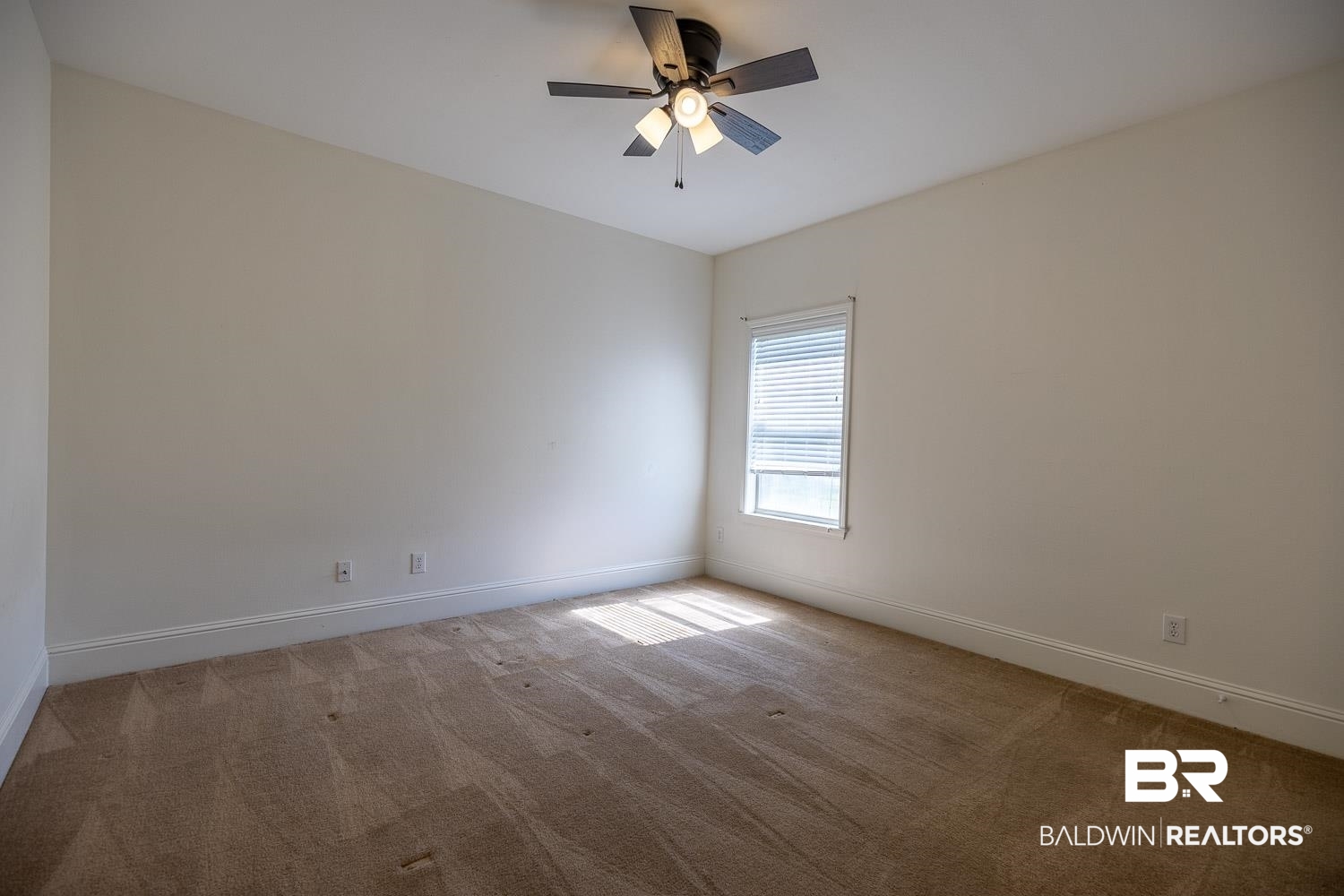 101 Normandy Street Fairhope, AL 36532 - Photo 13 of 18 Carpeted spare room with baseboards and ceiling fan