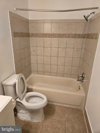 a bathroom with a toilet and a bath tub