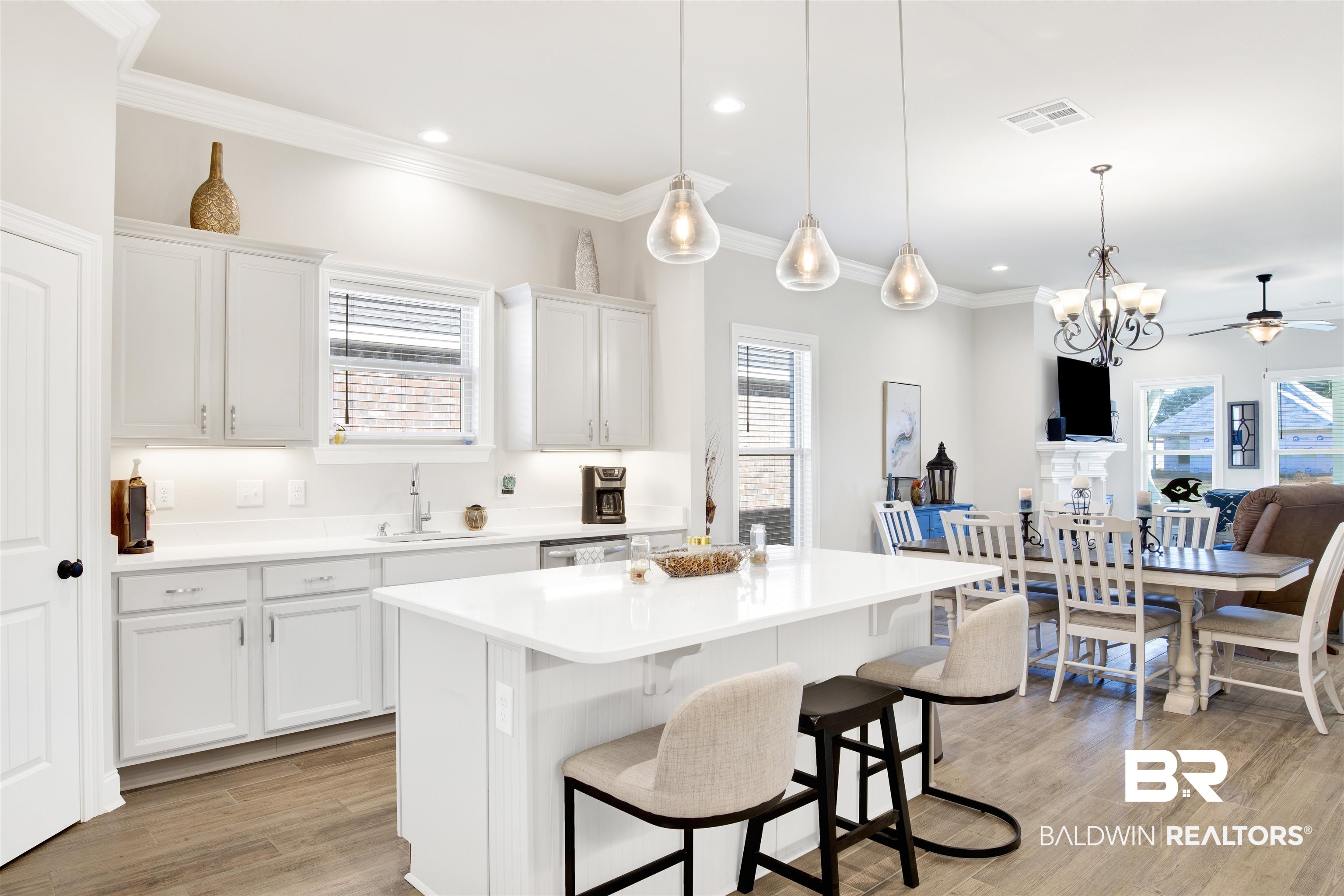 1406 Aldon Street Foley, AL 36535 - Photo 15 of 30 Kitchen with light gray cabinets, notable chandelier, plenty of natural light, and stainless sink