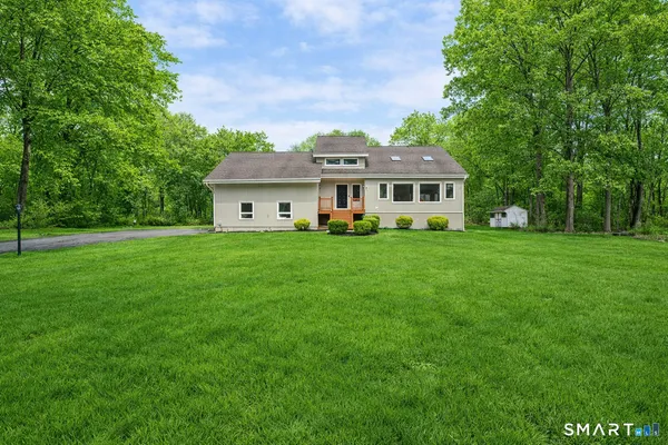 a front view of a house with a garden