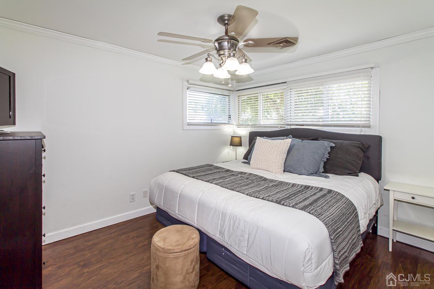 29 Ashley Road Edison, NJ 08817 - Photo 16 of 30 a bedroom with a bed and a chandelier
