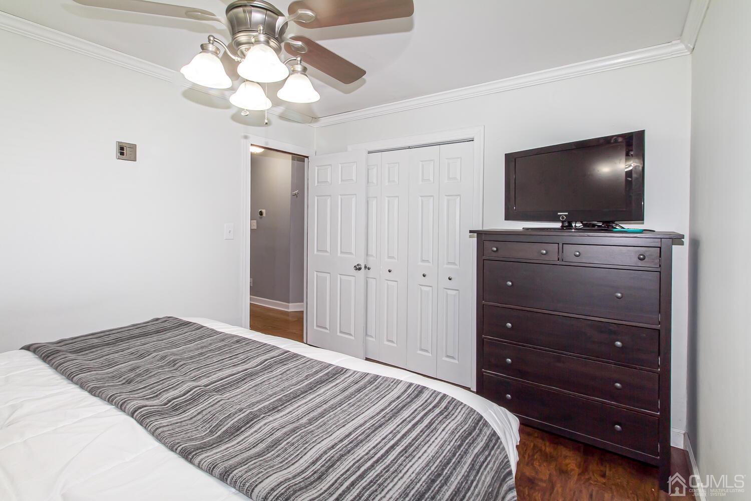 29 Ashley Road Edison, NJ 08817 - Photo 17 of 30 a bedroom with a bed and a flat tv screen on dresser