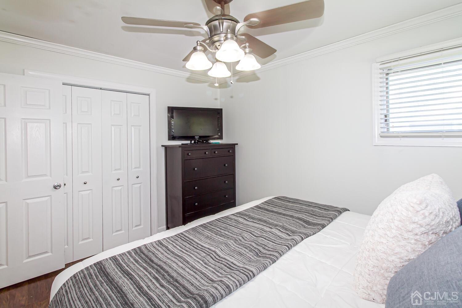 29 Ashley Road Edison, NJ 08817 - Photo 18 of 30 a bedroom with a bed and a flat screen tv