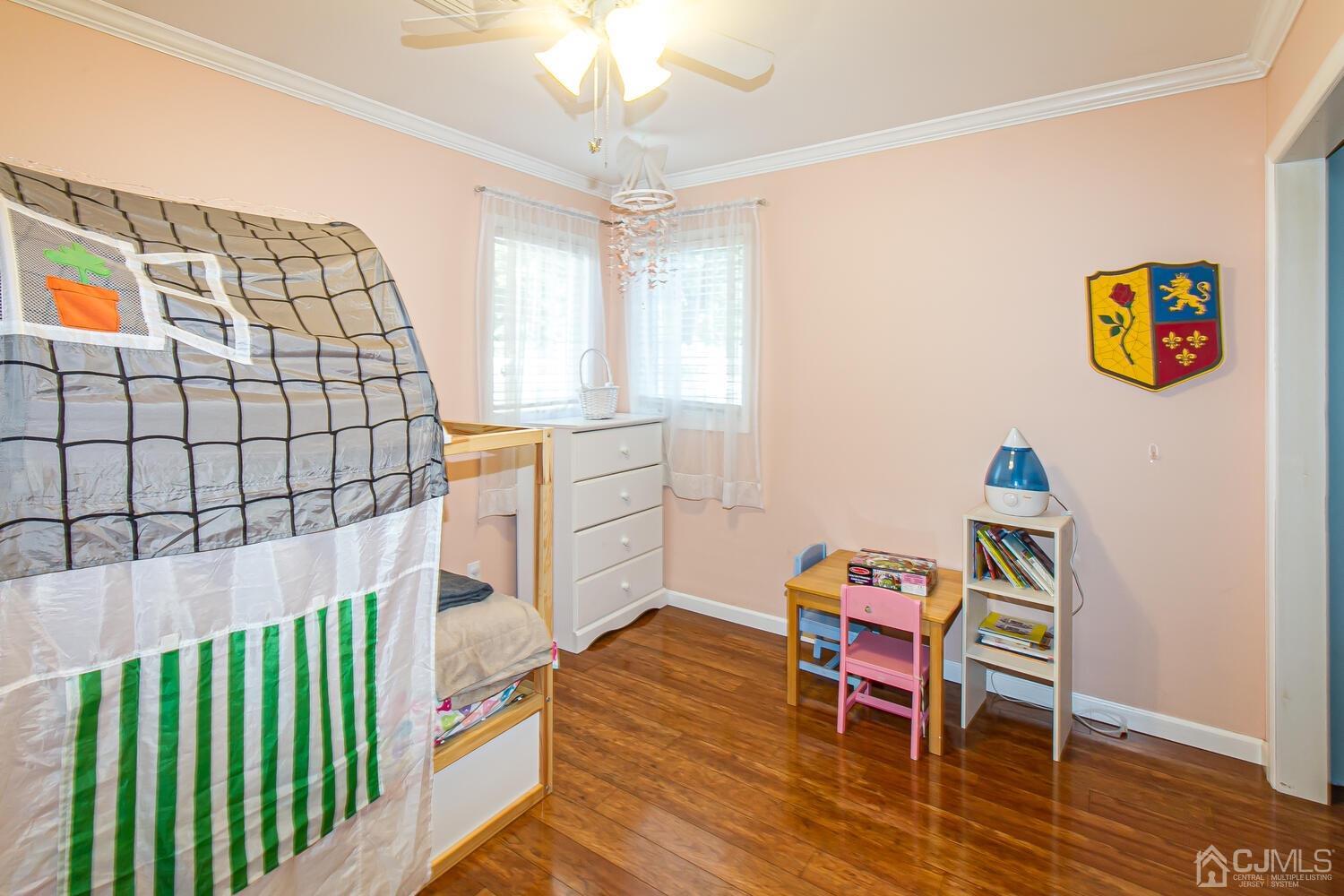 29 Ashley Road Edison, NJ 08817 - Photo 19 of 30 a living room with a baby crib furniture and a chandelier