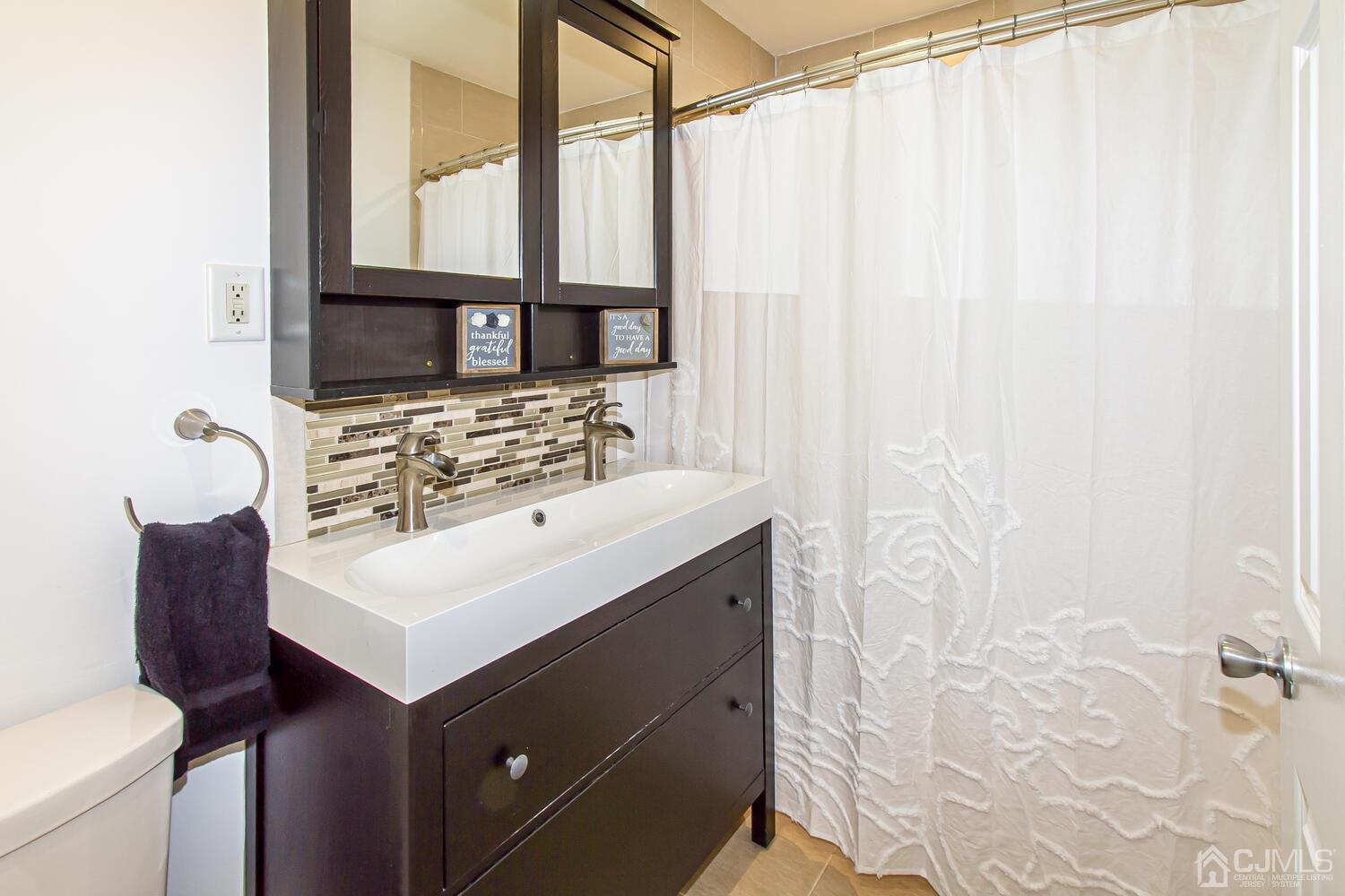29 Ashley Road Edison, NJ 08817 - Photo 23 of 30 a bathroom with a sink vanity and a mirror