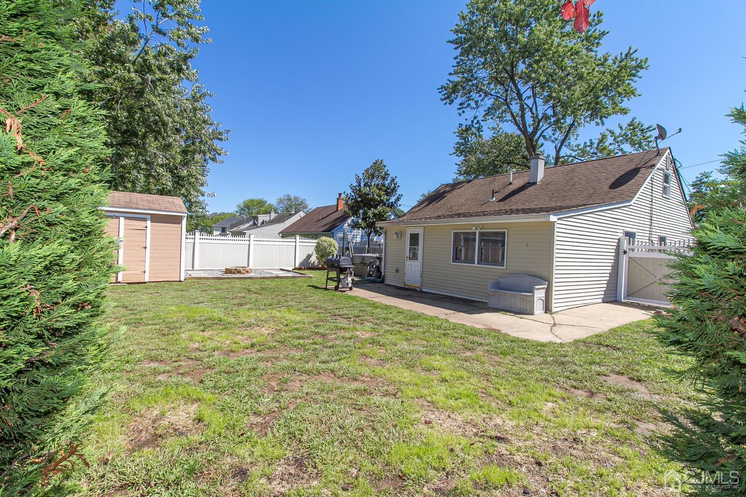 29 Ashley Road Edison, NJ 08817 - Photo 26 of 30 a white house with a large tree and yard