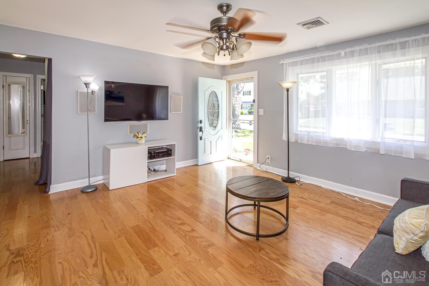 29 Ashley Road Edison, NJ 08817 - Photo 5 of 30 a living room with furniture a flat screen tv and floor to ceiling window