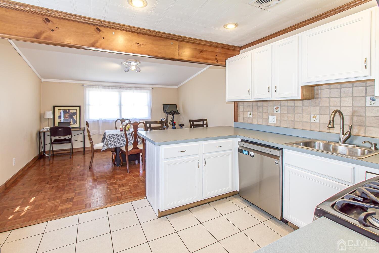29 Ashley Road Edison, NJ 08817 - Photo 7 of 30 a kitchen with a sink dining table and chairs