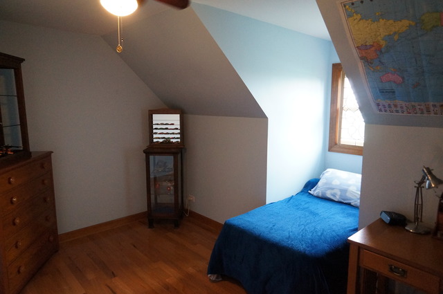 8101 West Bruns Road Monee, IL 60449 - Photo 18 of 25 a bedroom with a bed and wooden floor