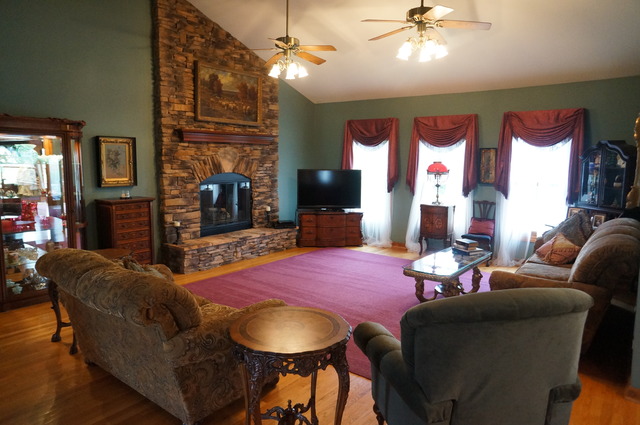 8101 West Bruns Road Monee, IL 60449 - Photo 5 of 25 a living room with furniture a fireplace and a flat screen tv