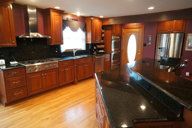 8101 West Bruns Road Monee, IL 60449 - Photo 7 of 25 a kitchen with stainless steel appliances granite countertop sink stove and granite counter top