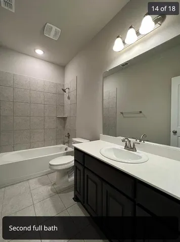 a bathroom with a bathtub a sink a toilet and a mirror