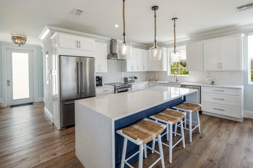814 39th Street, Unit 14 Marathon, FL 33050 - Photo 21 of 39 a kitchen with stainless steel appliances a dining table chairs refrigerator and sink