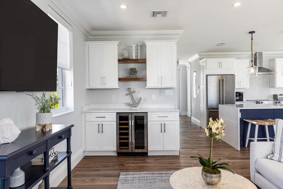 814 39th Street, Unit 14 Marathon, FL 33050 - Photo 3 of 39 a kitchen with stainless steel appliances granite countertop a refrigerator a stove a sink dishwasher and white cabinets with wooden floor