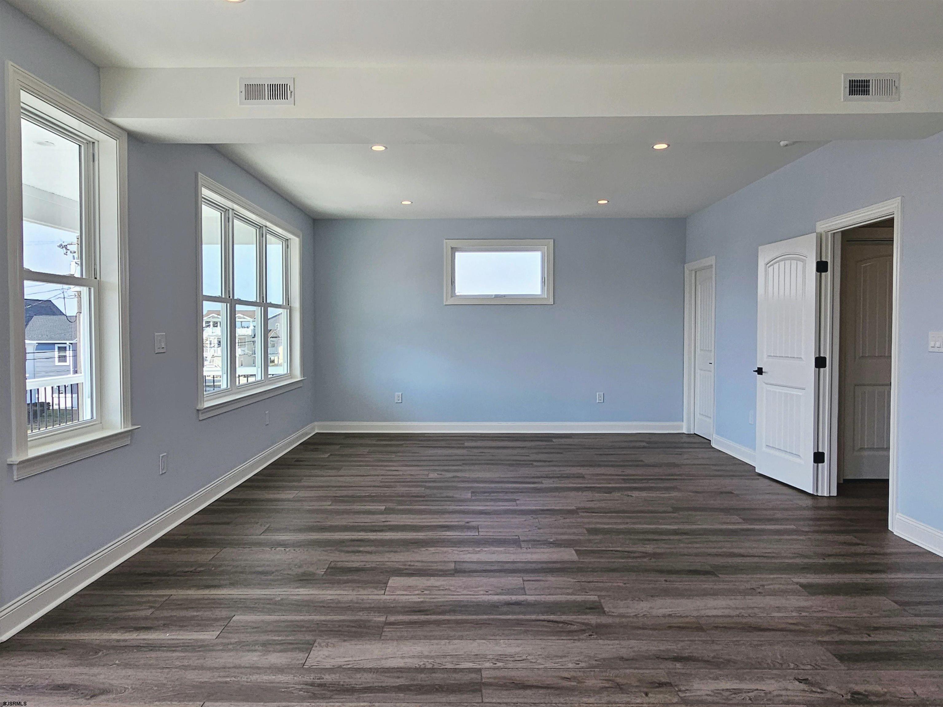 222 8th Street South Brigantine, NJ 08203 - Photo 19 of 27 a view of an empty room with wooden floor and a window