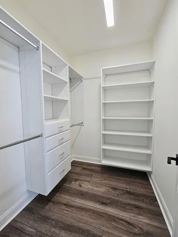 a view of walk in closet with empty racks