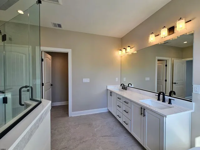a bathroom with a double vanity sink and a mirror