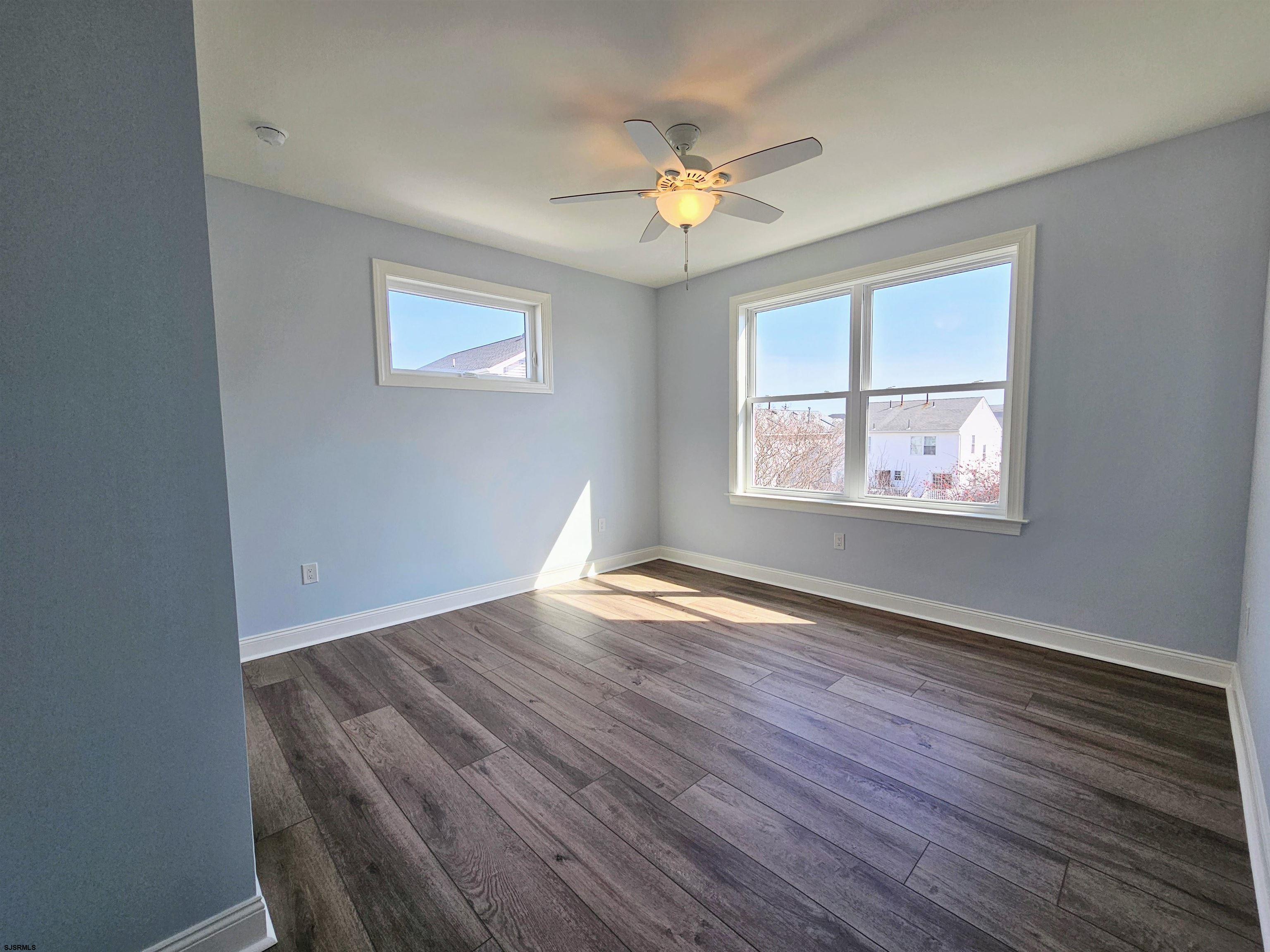 222 8th Street South Brigantine, NJ 08203 - Photo 25 of 27 a view of an empty room with wooden floor and a window