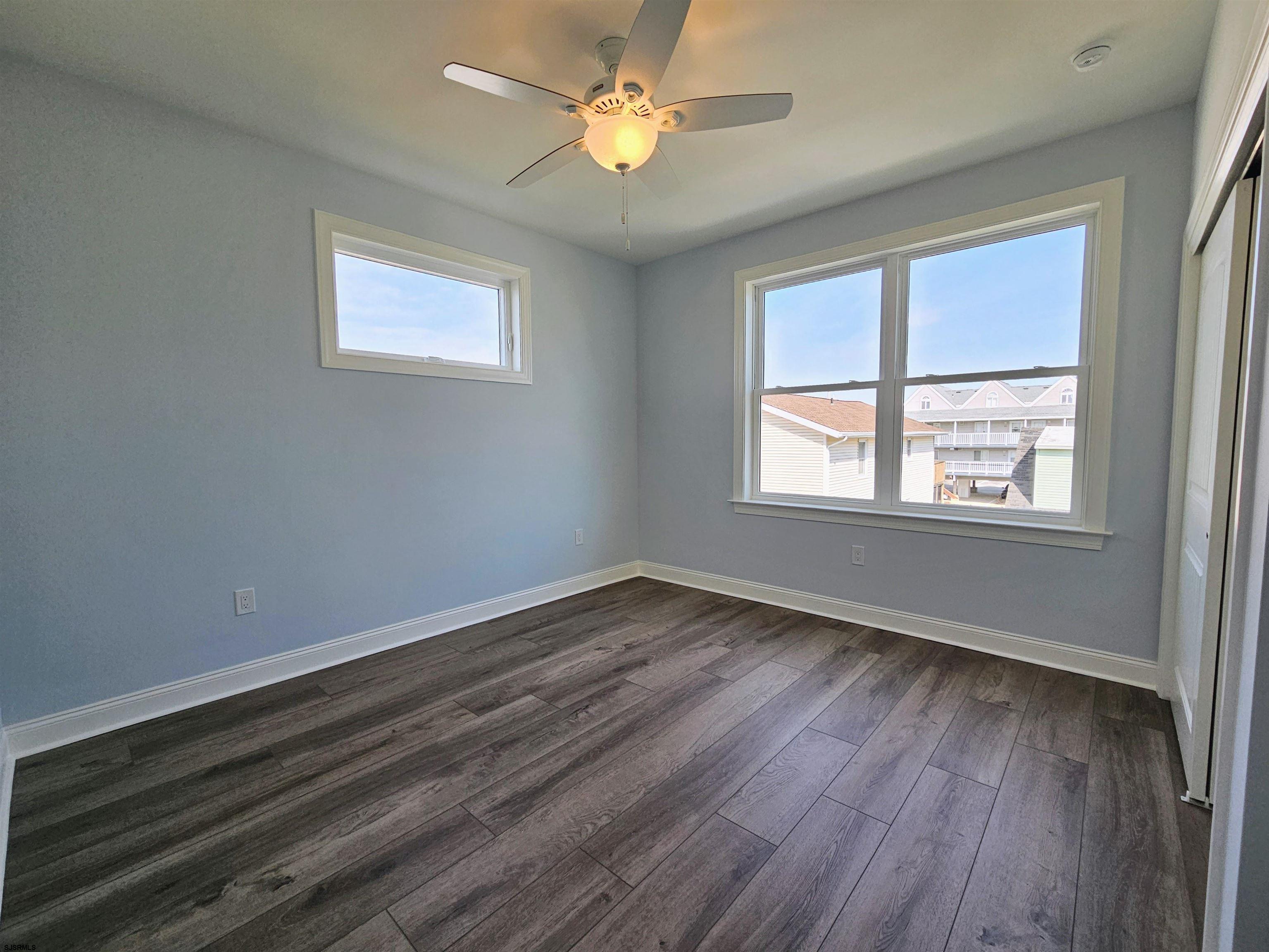 222 8th Street South Brigantine, NJ 08203 - Photo 27 of 27 a view of an empty room with wooden floor and a window