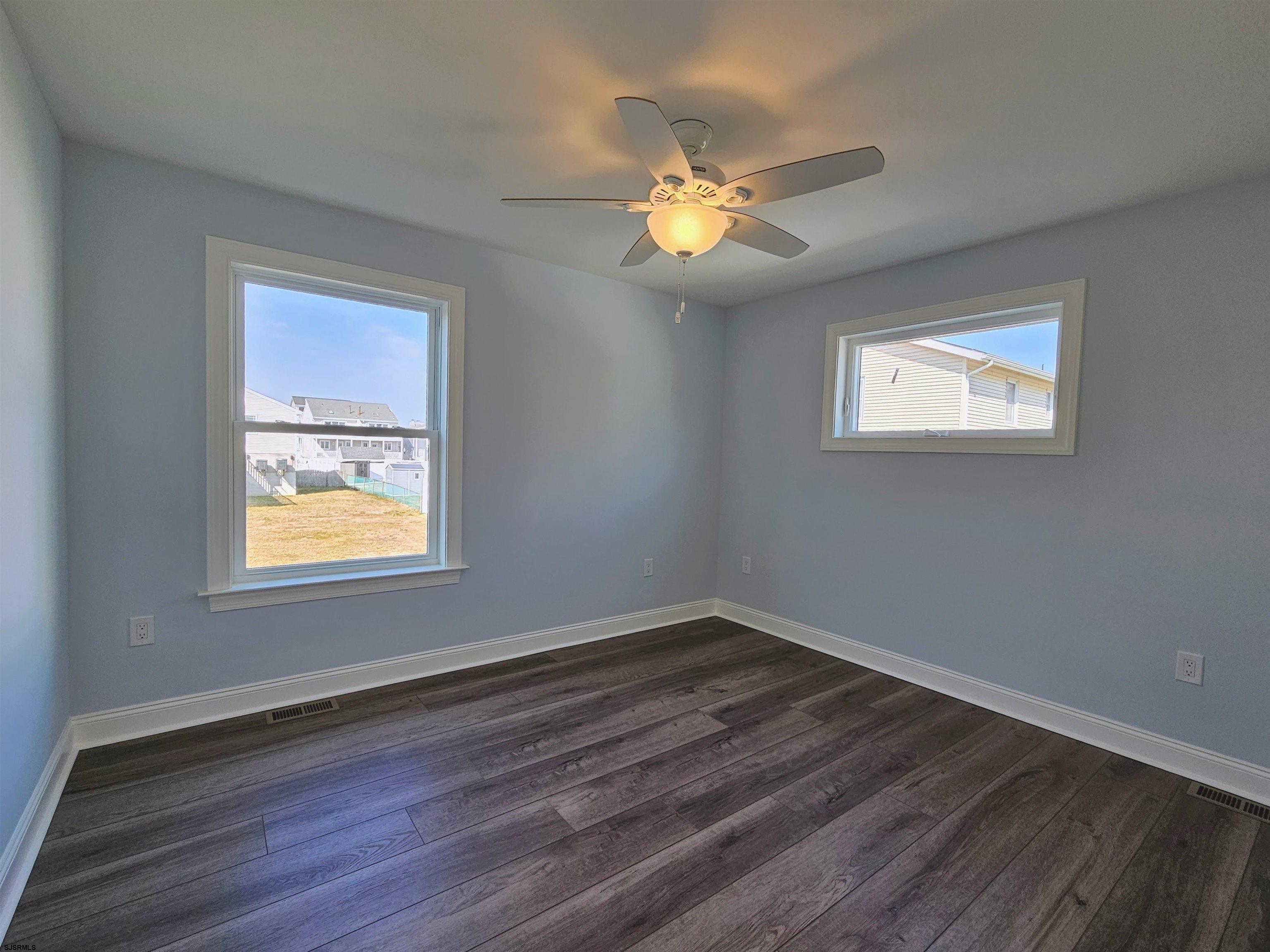 222 8th Street South Brigantine, NJ 08203 - Photo 6 of 27 a view of an empty room with wooden floor and a window