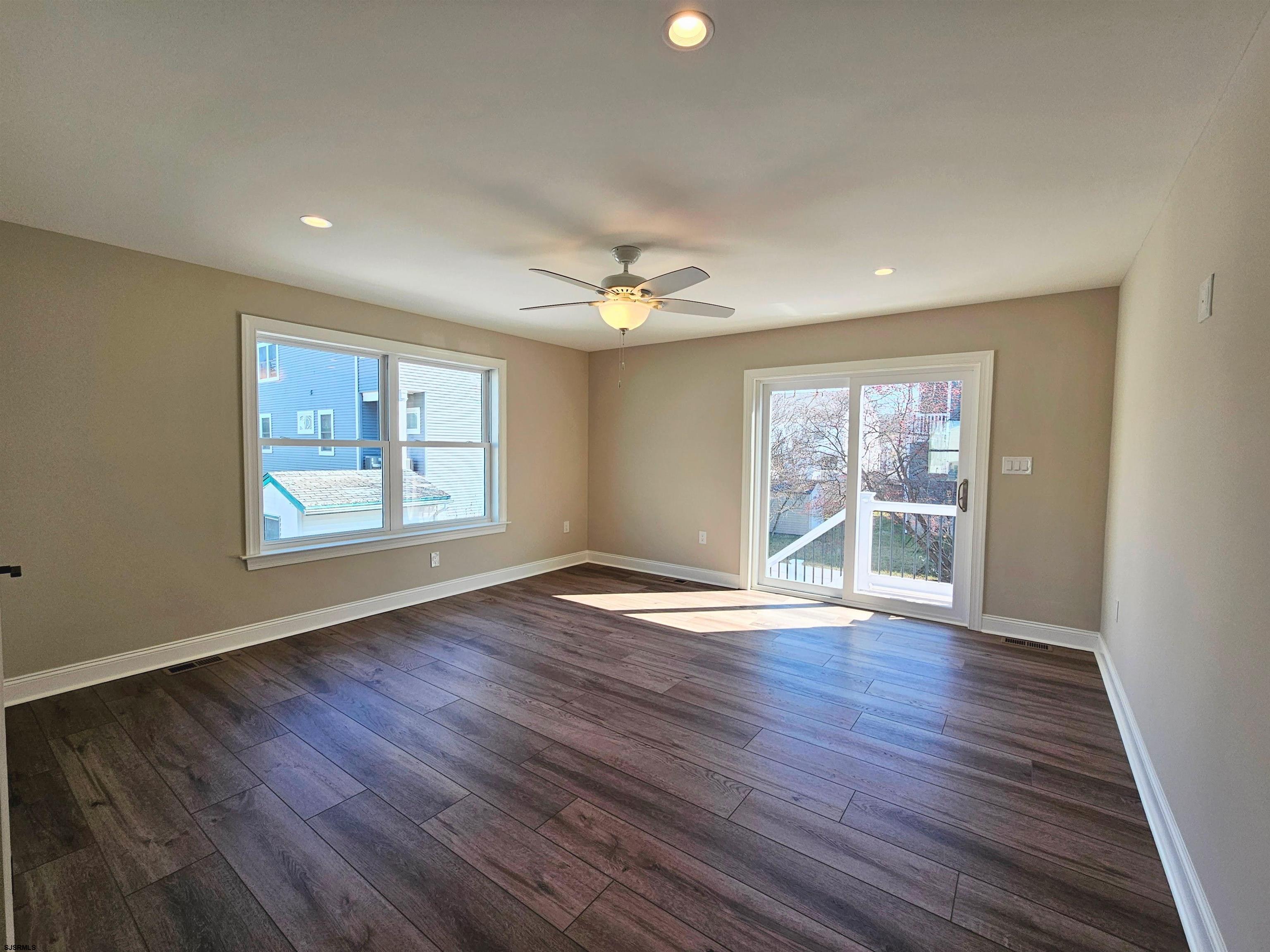 222 8th Street South Brigantine, NJ 08203 - Photo 7 of 27 an empty room with wooden floor and windows