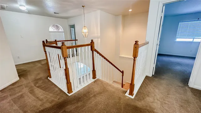 a view of a hallway with staircase