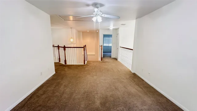 an empty room with an entrance and wooden floor