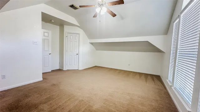 an empty room with windows and mirror