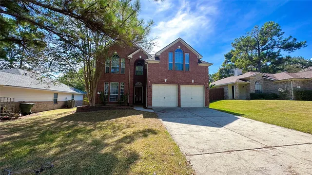 a view of a house with a yard and garage