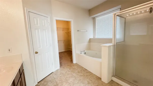 a bathroom with a tub shower and a sink