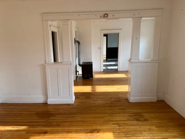 a view of room with window and refrigerator