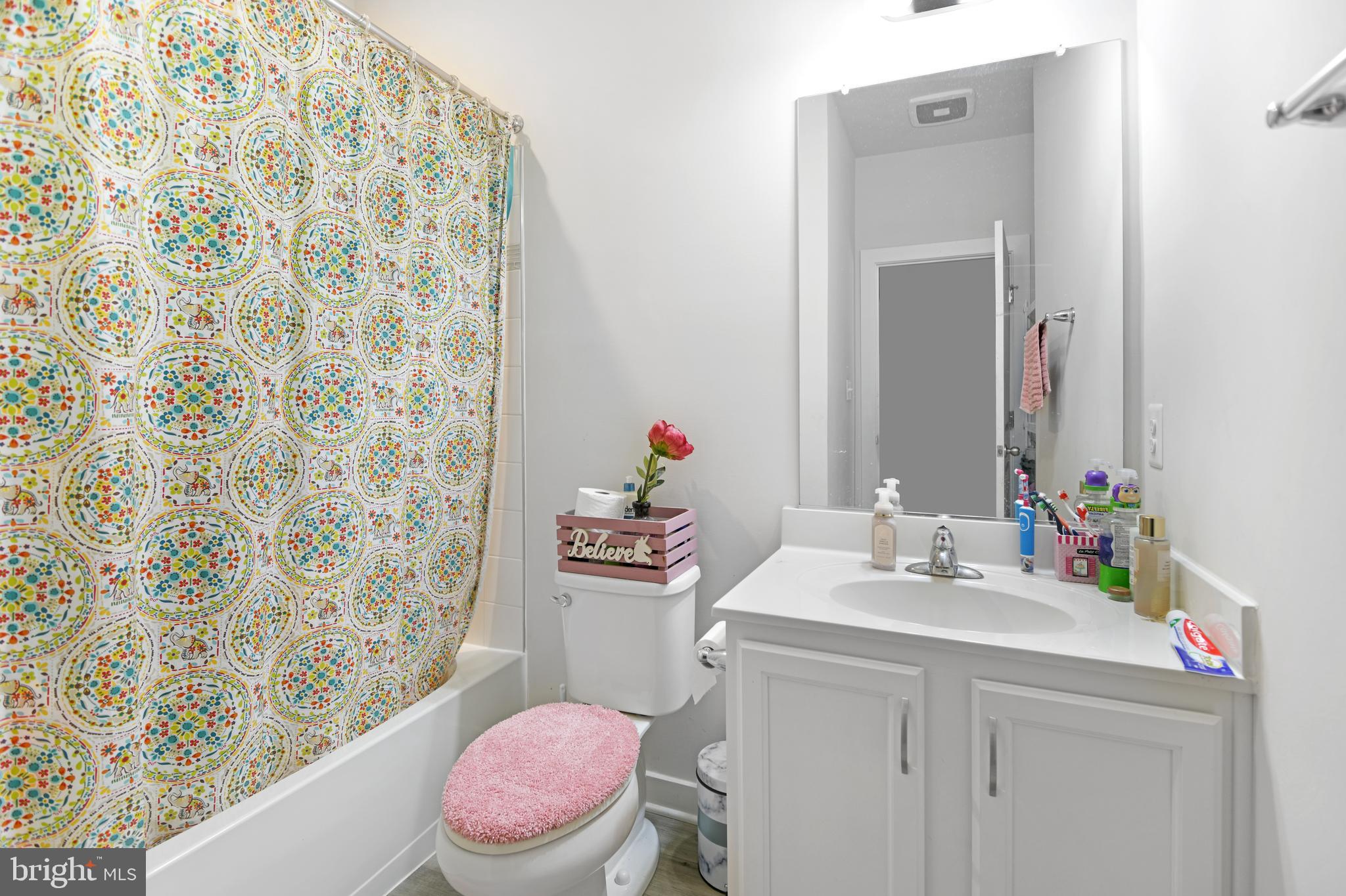 8910 Shady Pines Drive Frederick, MD 21704 - Photo 11 of 22 a bathroom with a sink mirror vanity and toilet