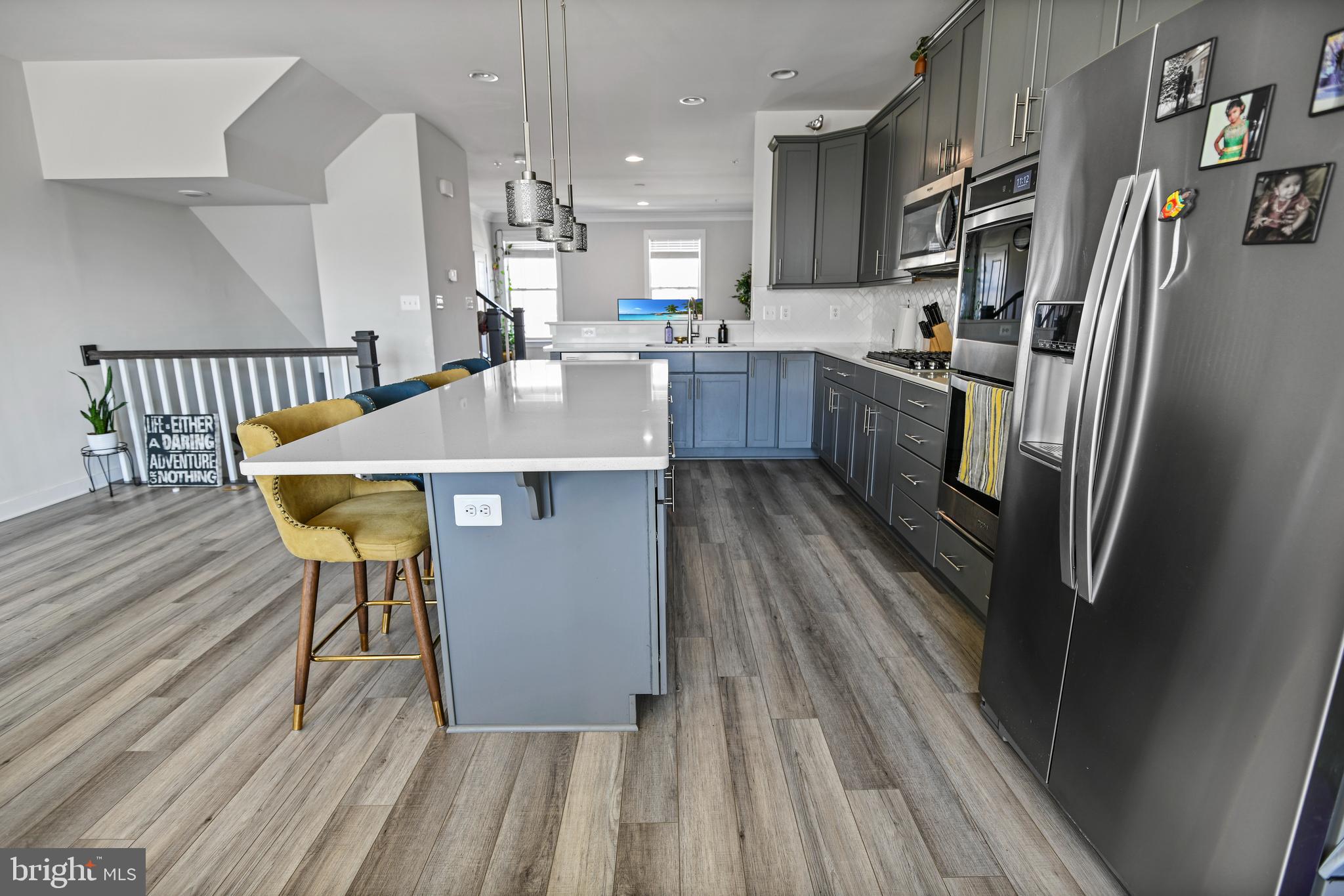 8910 Shady Pines Drive Frederick, MD 21704 - Photo 4 of 22 a kitchen with stainless steel appliances granite countertop a refrigerator a stove and a wooden floors
