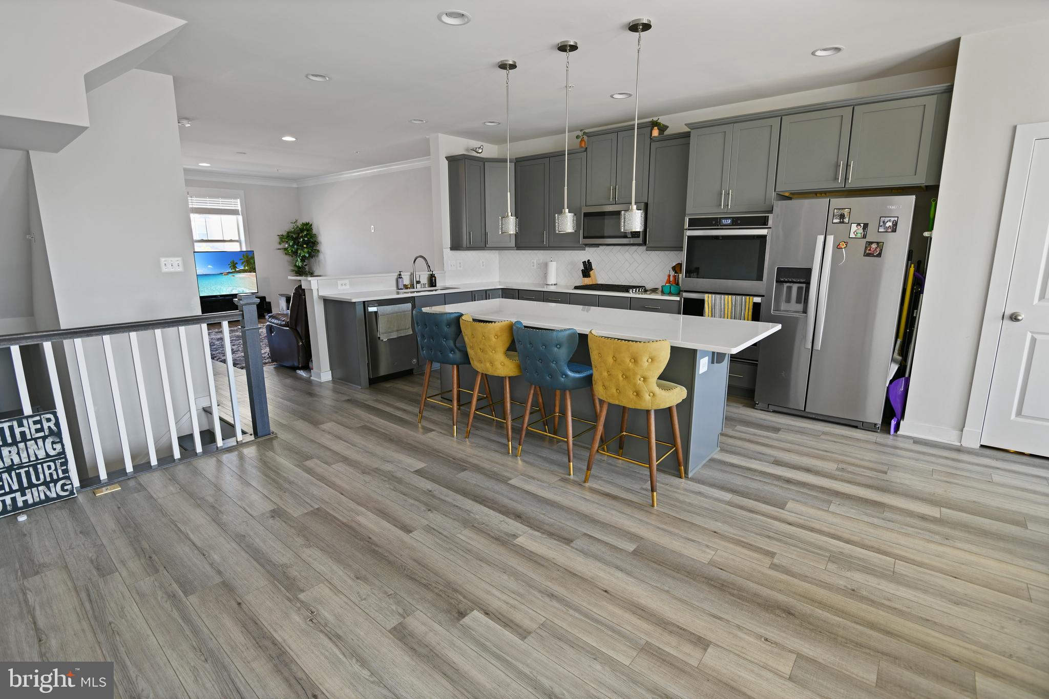 8910 Shady Pines Drive Frederick, MD 21704 - Photo 5 of 22 a kitchen with stainless steel appliances granite countertop a refrigerator a stove top oven a sink dishwasher and white cabinets with wooden floor