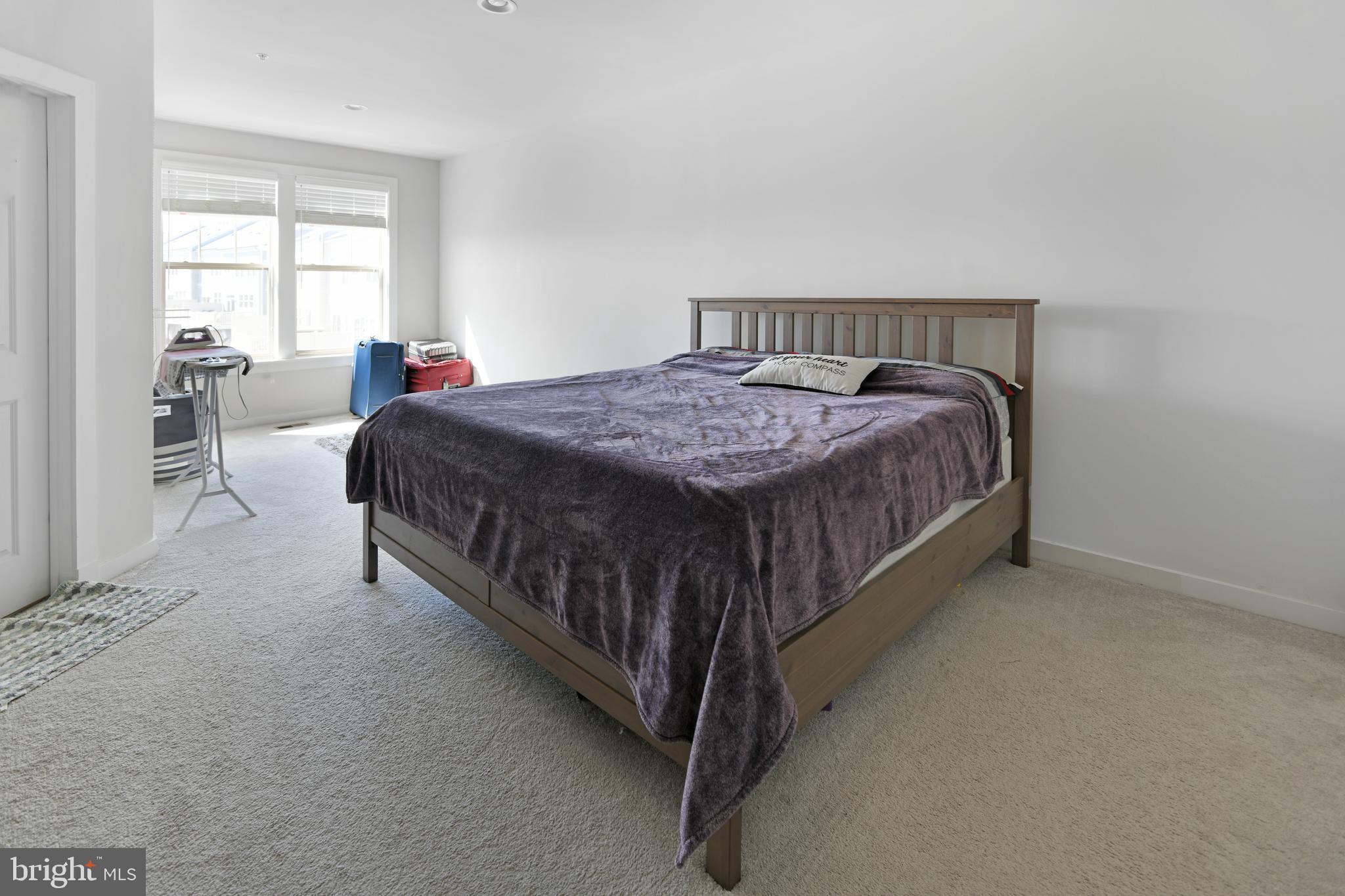 8910 Shady Pines Drive Frederick, MD 21704 - Photo 7 of 22 a bed sitting in a bedroom next to a window
