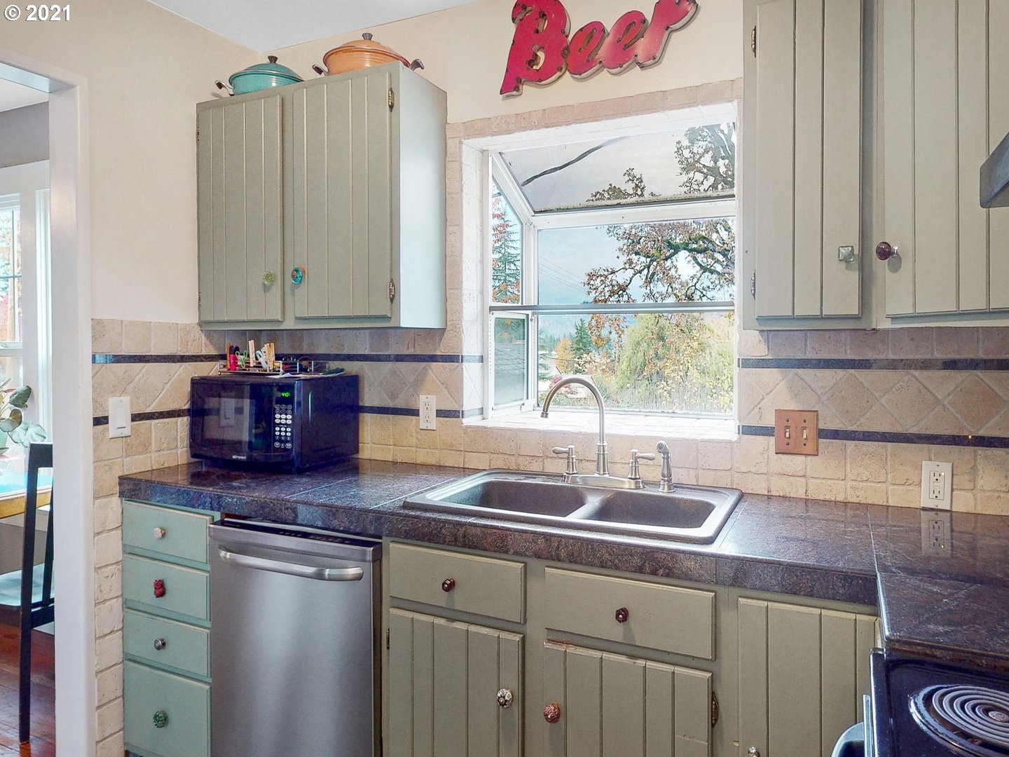 729 South 57th Street Springfield, OR 97478 - Photo 8 of 23 a kitchen with granite countertop a sink a window and cabinets