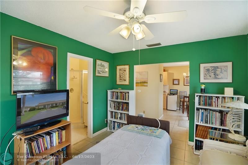 8625 Boca Drive, Unit 12 Boca Raton, FL 33433 - Photo 13 of 42 a bedroom with furniture and a flat screen tv